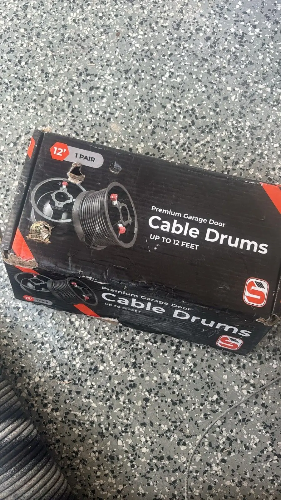Box of new garage door cable drums