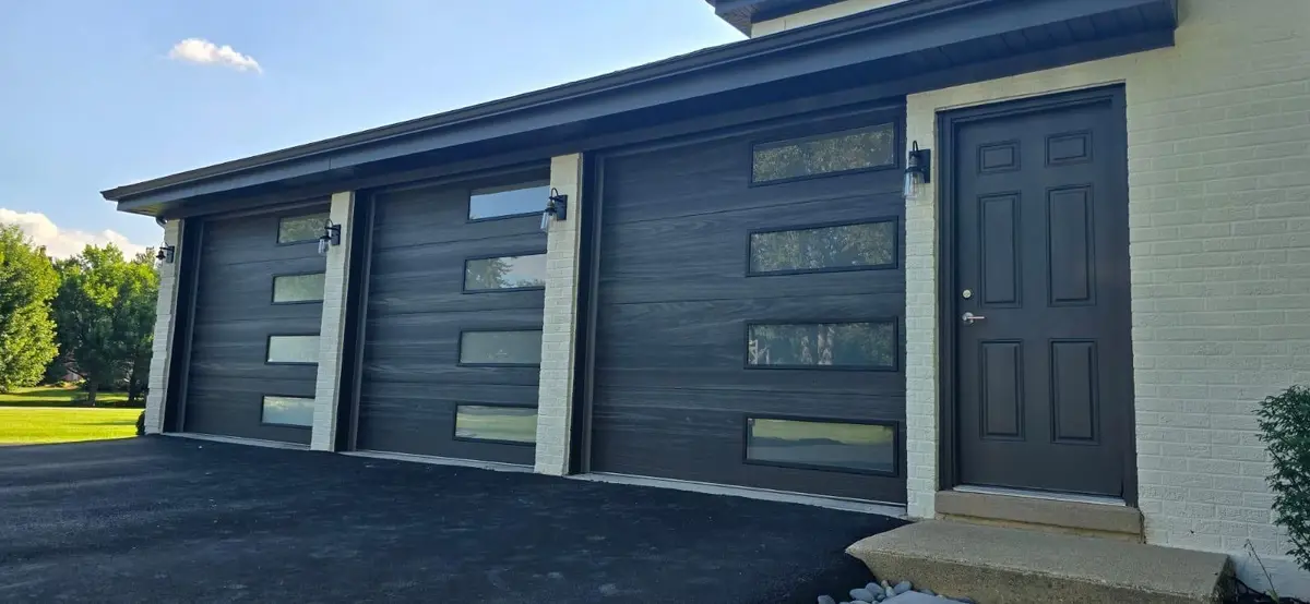Three dark modern garage doors with offset side windows