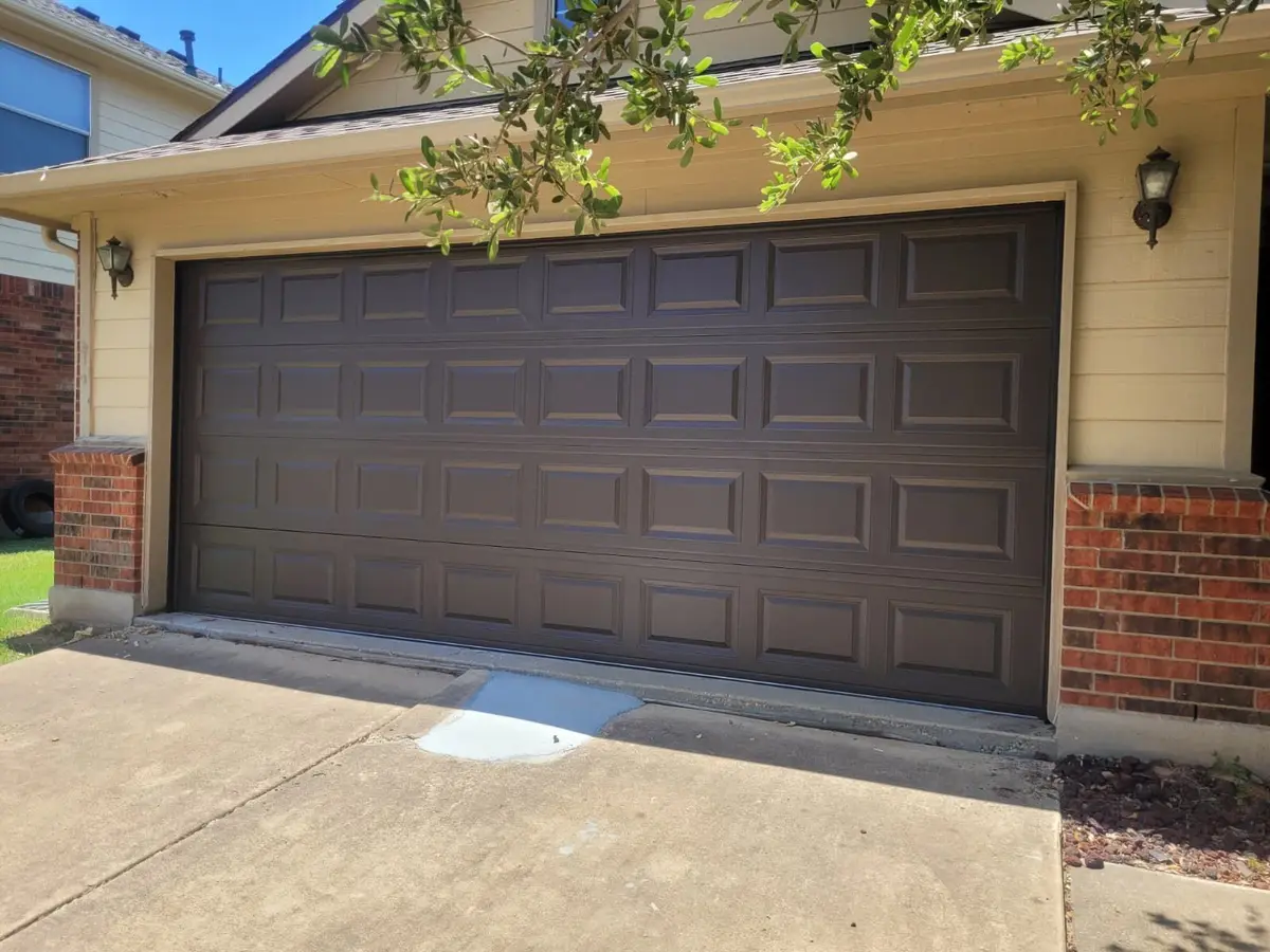 After: dark brown raised panel double garage door installed by Tier One