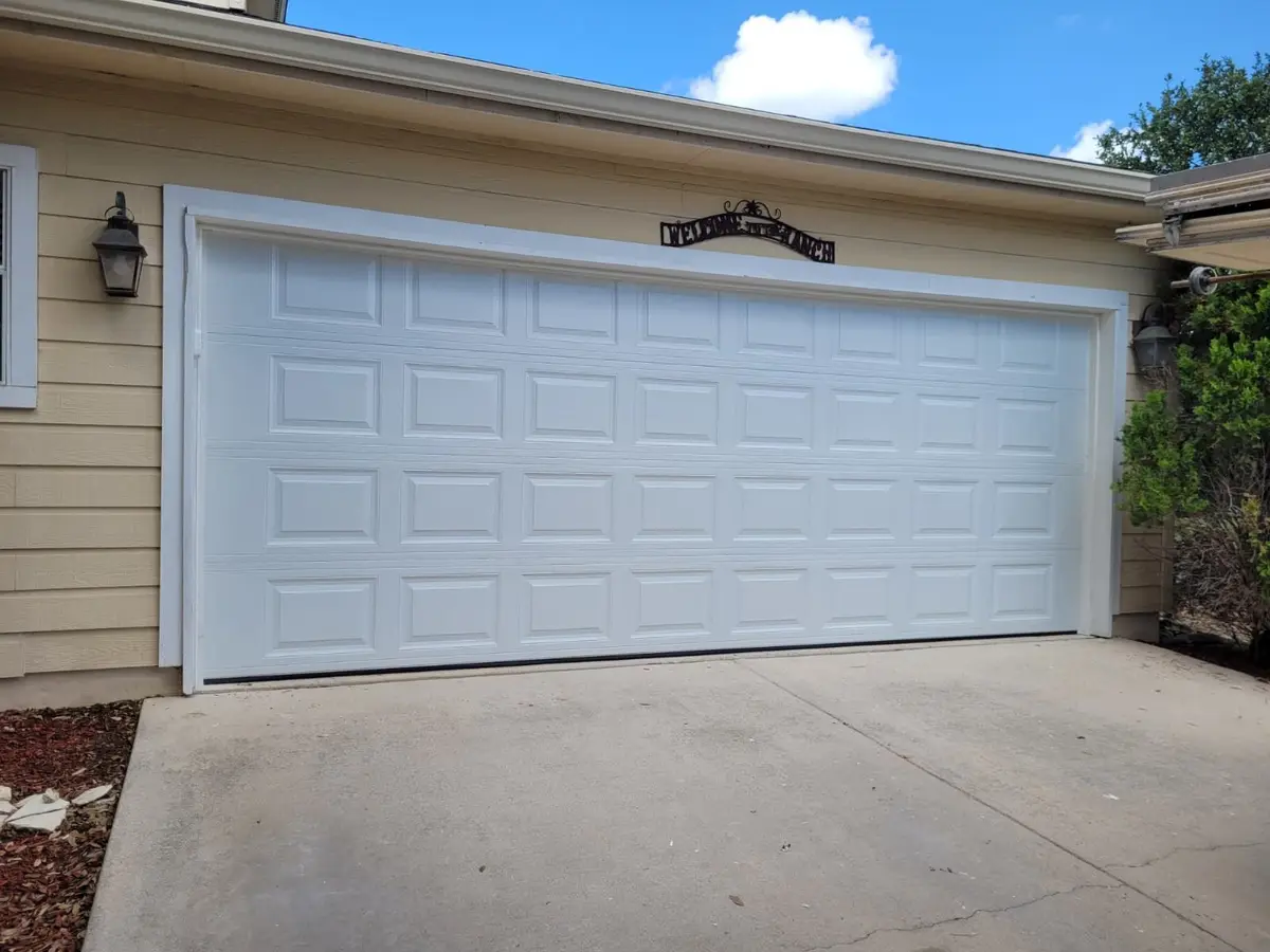 After: white short panel double garage door installed by Tier One