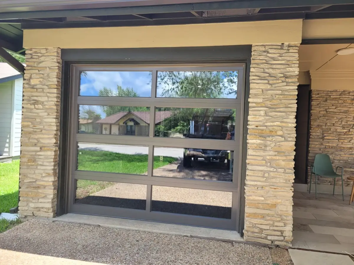 After: bronze framed full view glass garage door installed by Tier One in Austin 78757