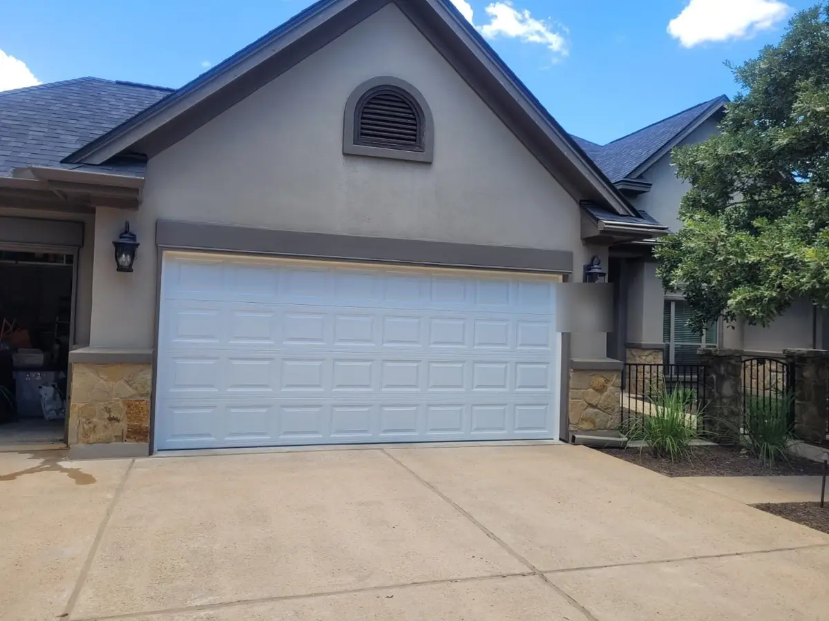 After: white raised panel double garage door installed by Tier One