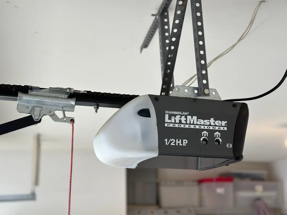LiftMaster half horsepower garage door opener and rail on a garage ceiling