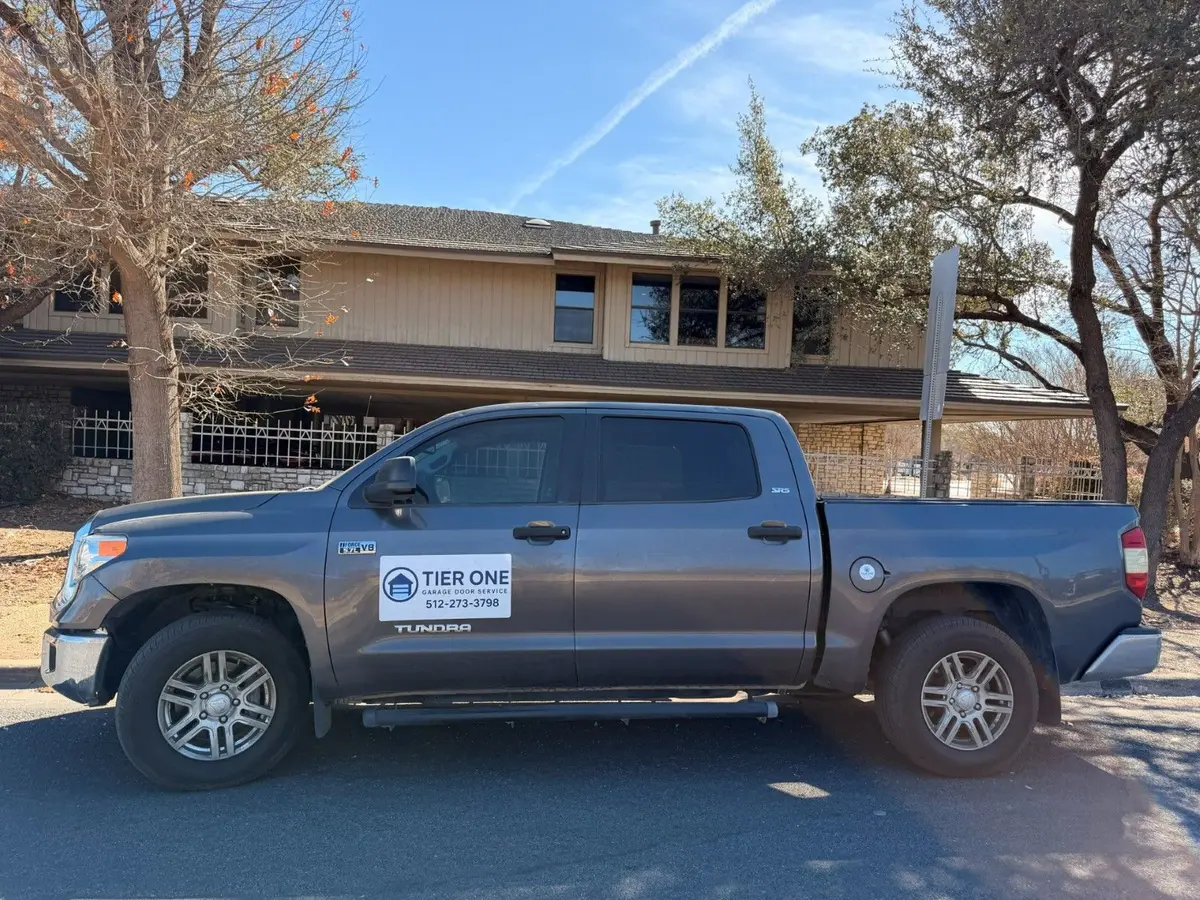 Tier One Garage Door Service truck with the company logo and phone number on the door