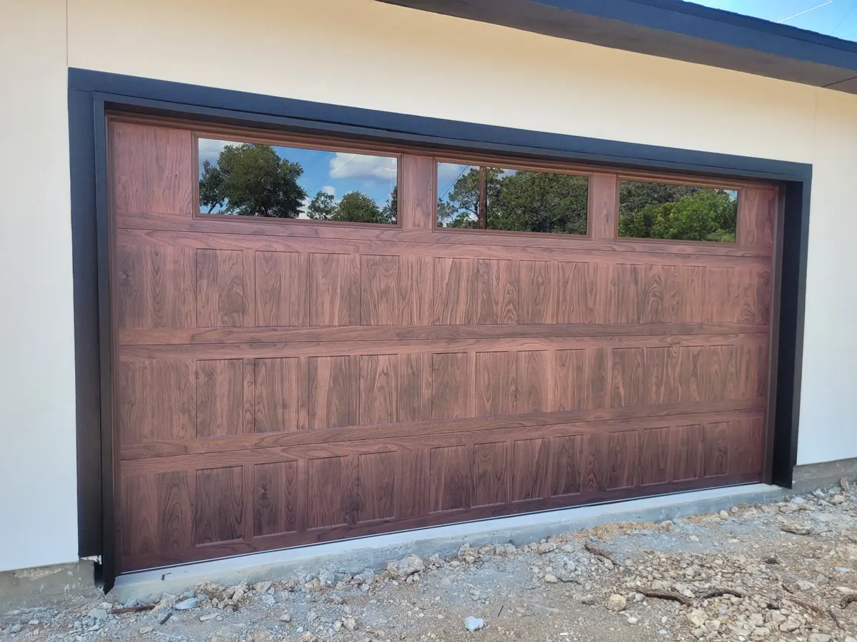New wood look garage door with windows across the top section